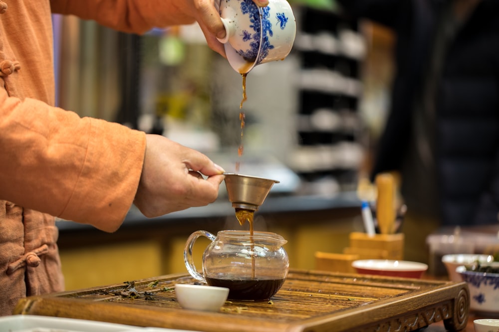 person pouring tea