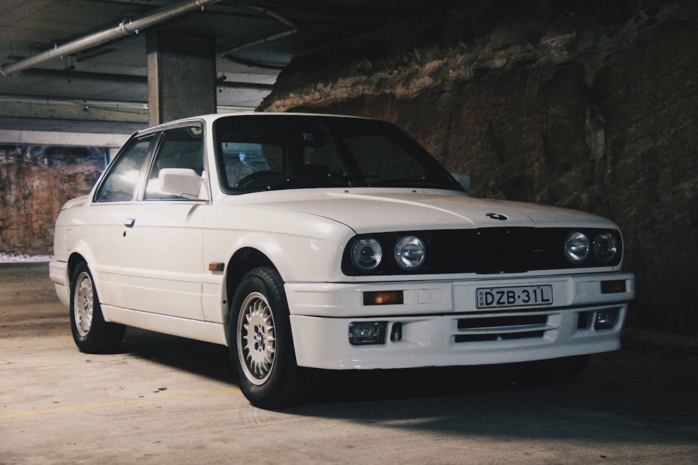 white BMW sedan on parking lot