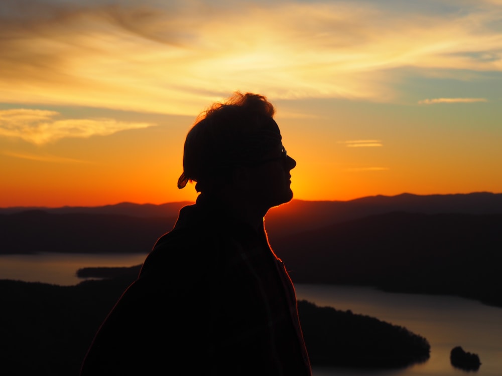 silhouette of person facing right side during golden hour