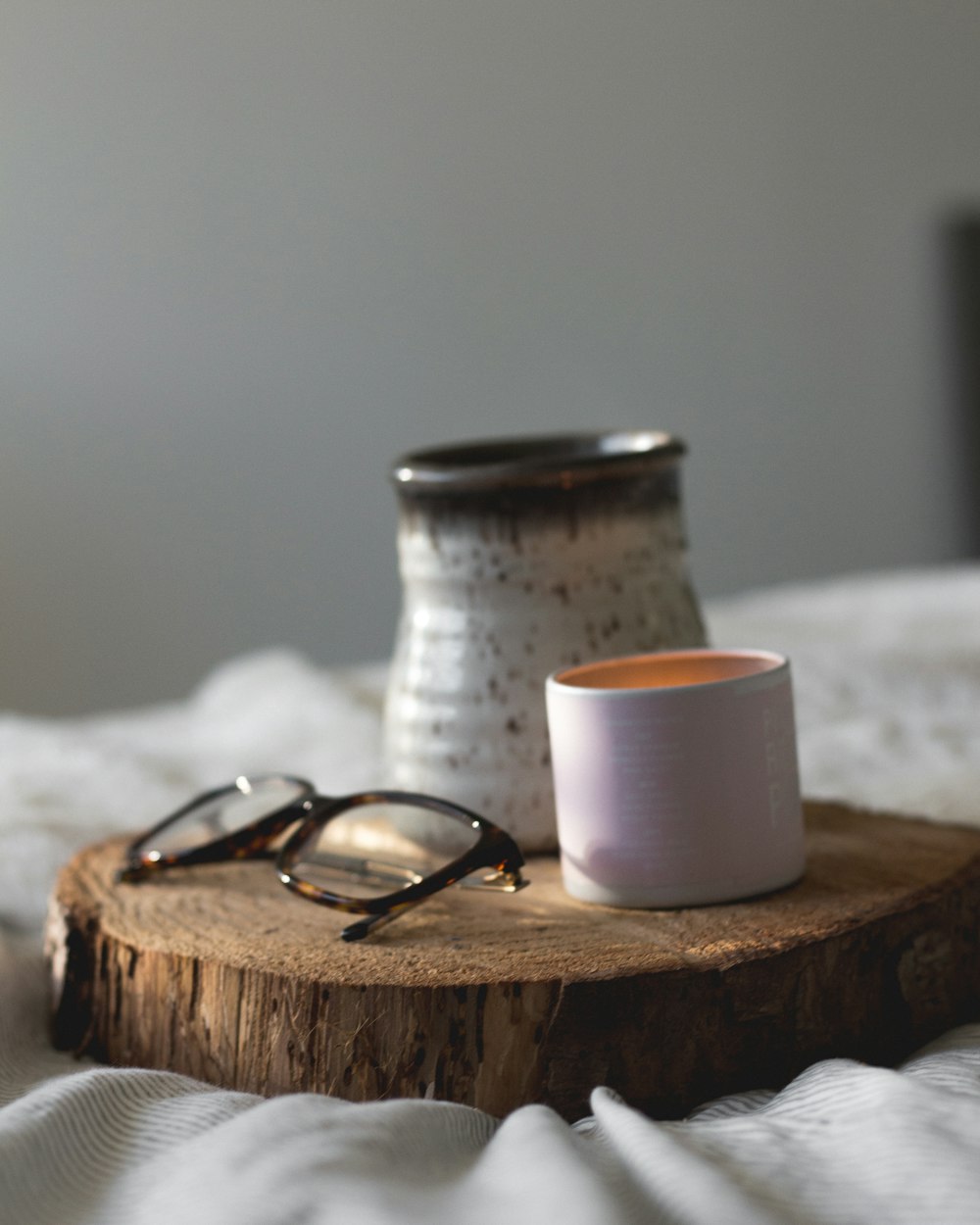 white ceramic mug and eyeglasses