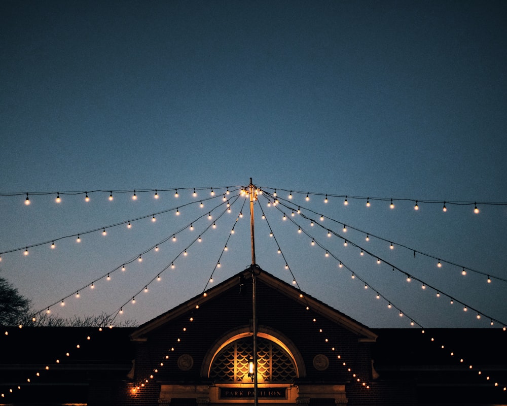 lights above house under blue sky at dawn