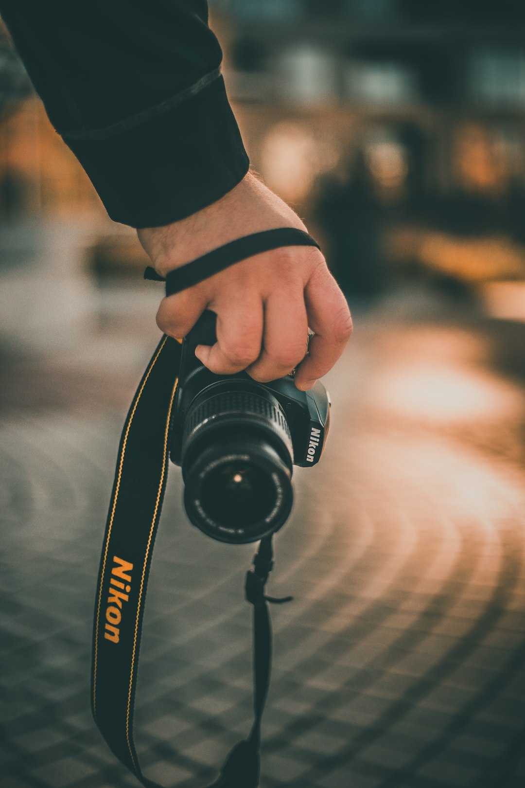 person holding black Nikon DSLR camera