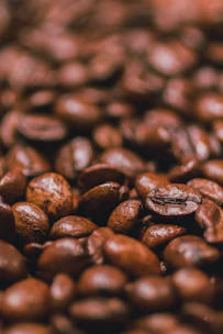 Close-up of rich Puerto Rican coffee beans with the island's flag softly blurred in the background
