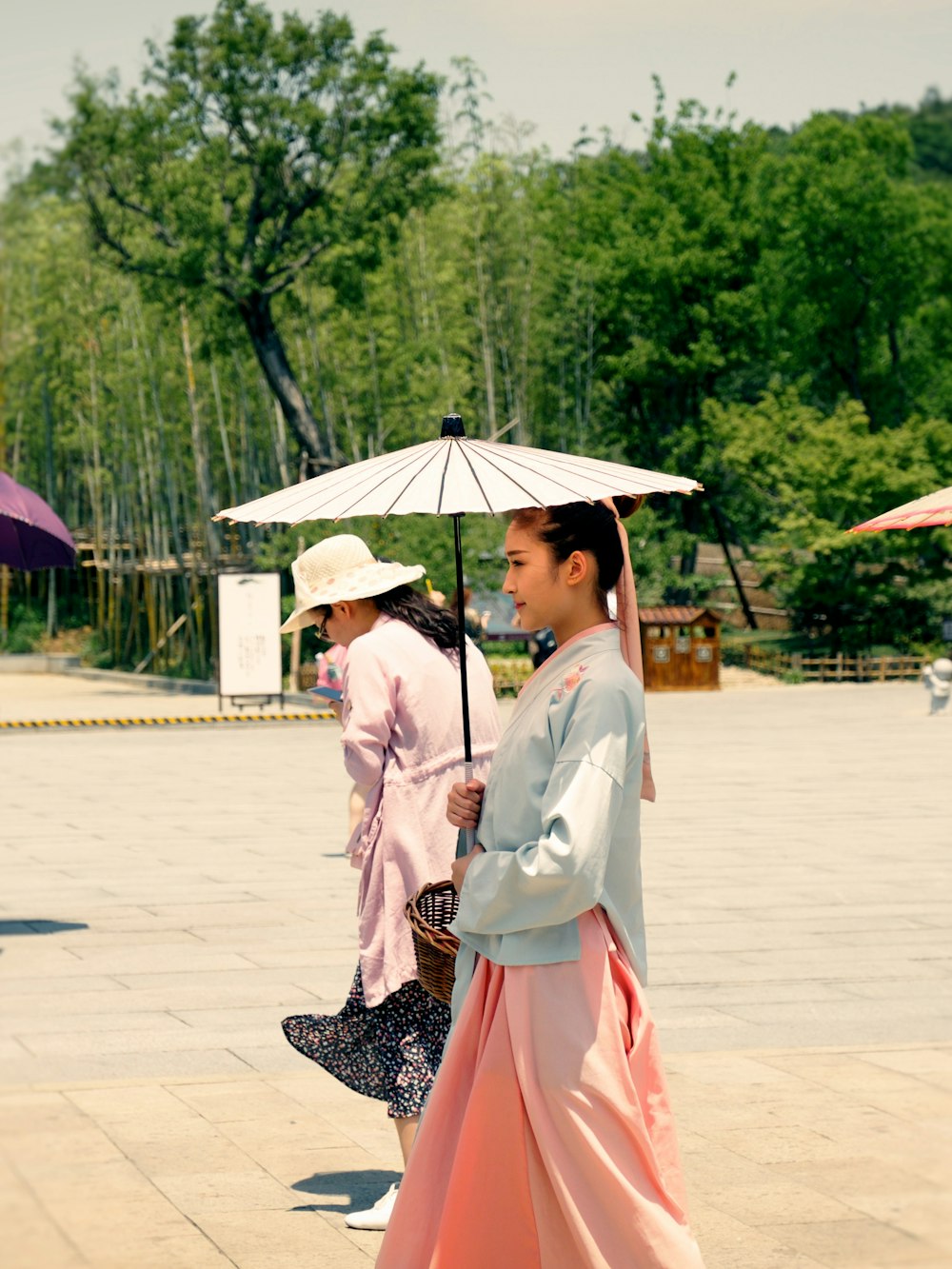 woman holding white umbrella