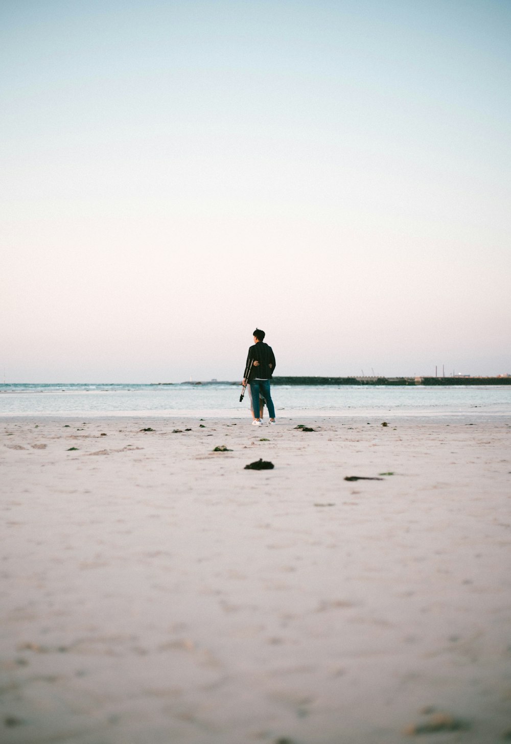 person standing beside seashore