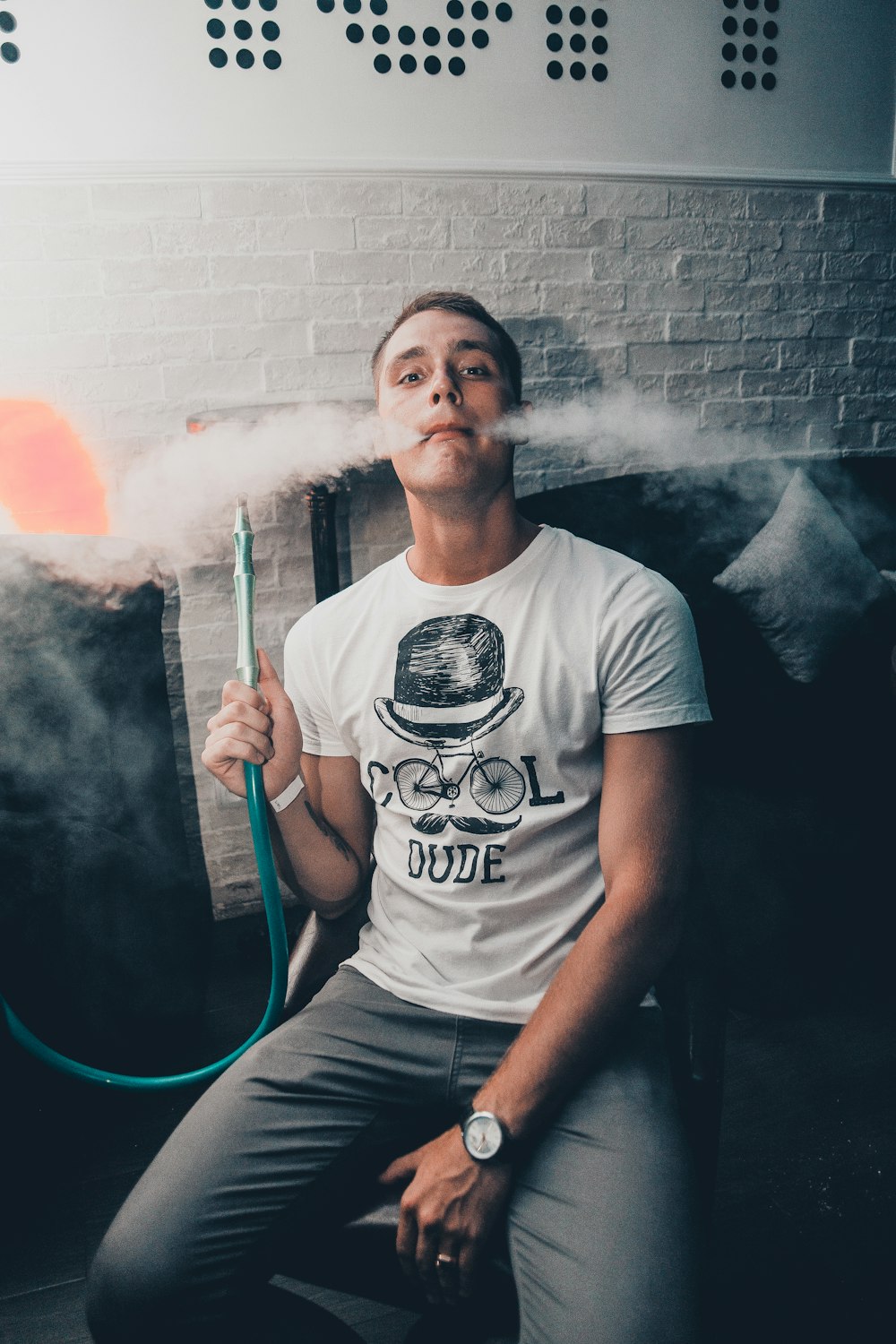 man sitting while vaping