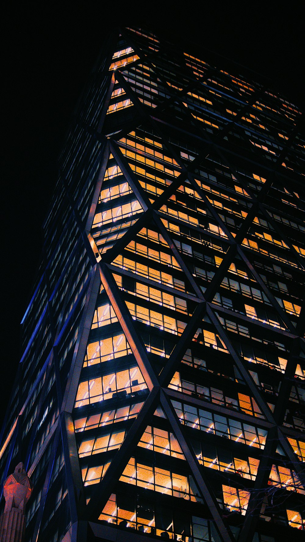 black curtain wall building during nighttime