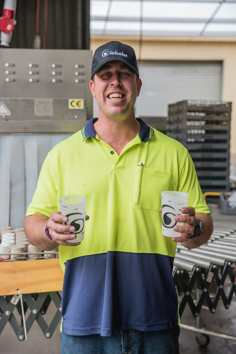 man carrying two empty glass cups