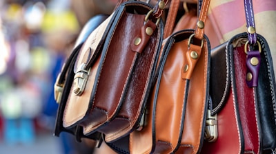 three assorted-color leather crossbody bags