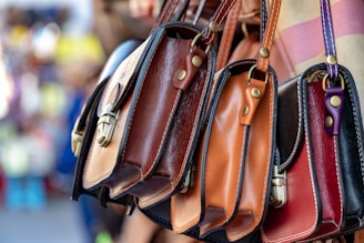 three assorted-color leather crossbody bags