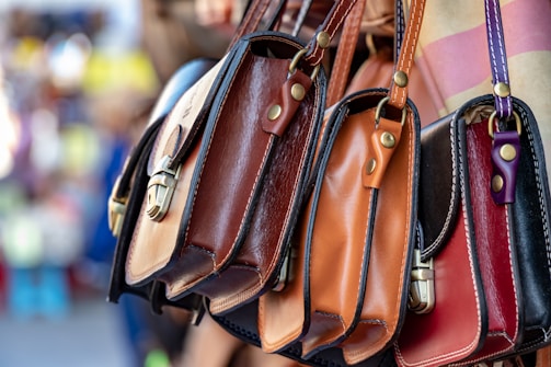 three assorted-color leather crossbody bags