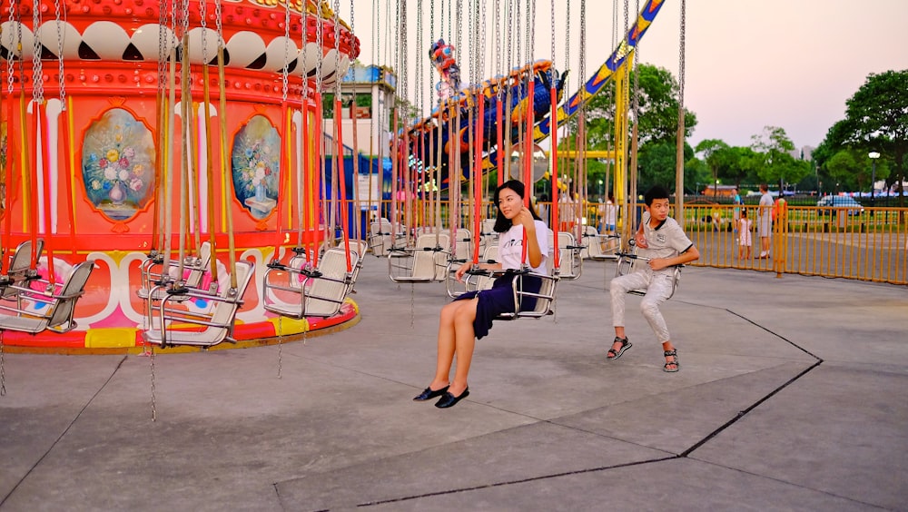 woman and boy swing on play ground