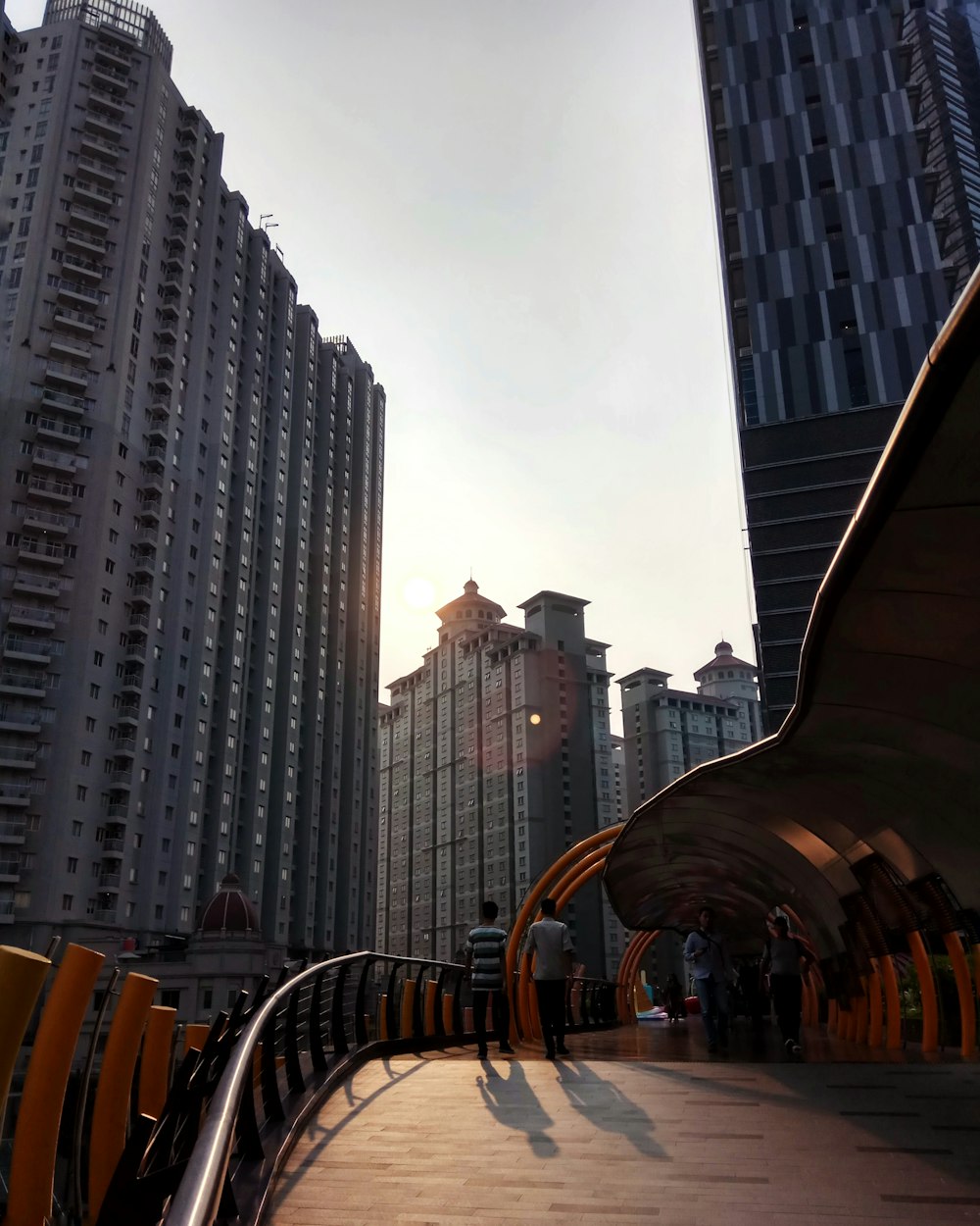 several people walking on bridge