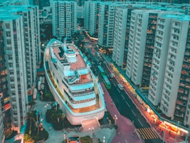 white boat building surrounded with high-rise buildings