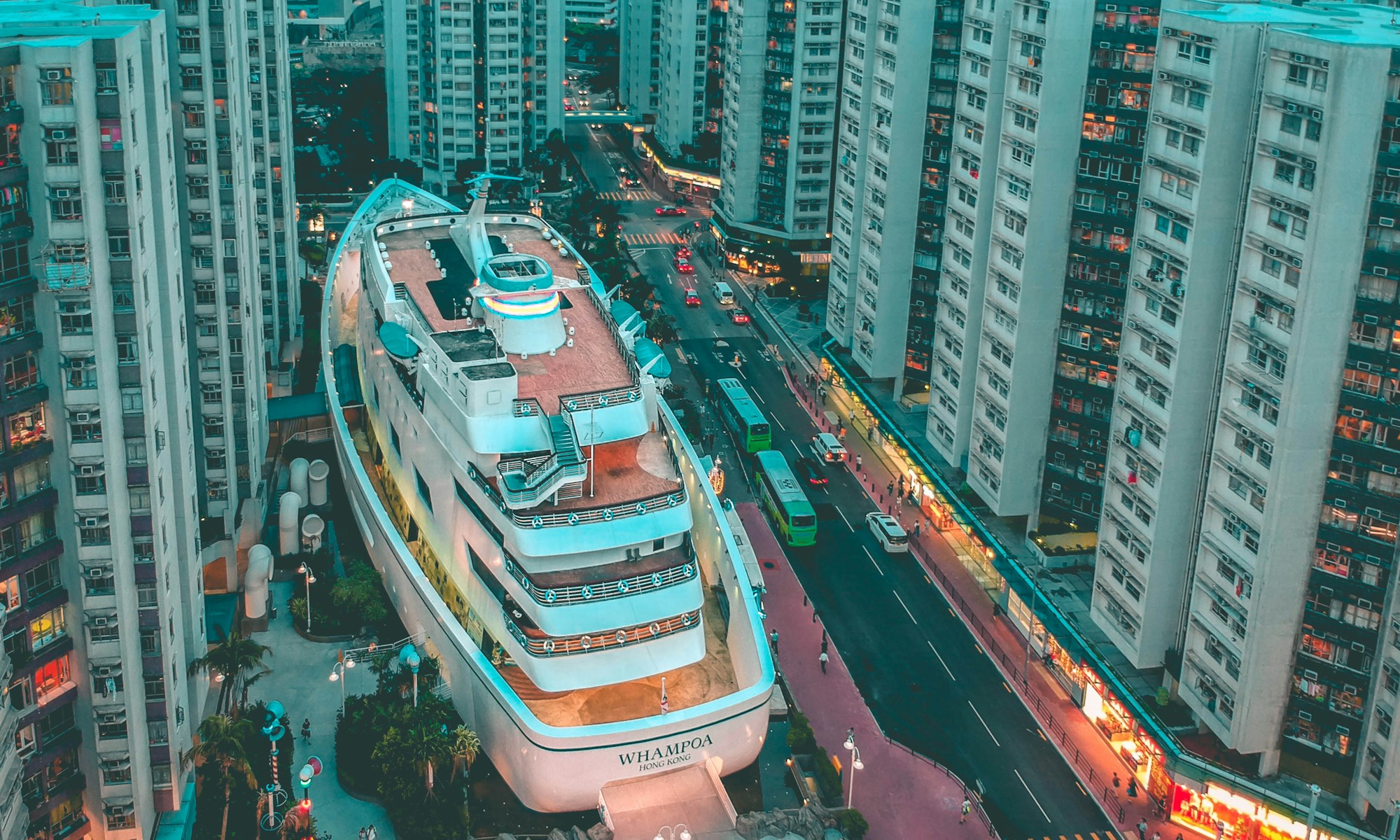 SGN TV. white boat building surrounded with high-rise buildings