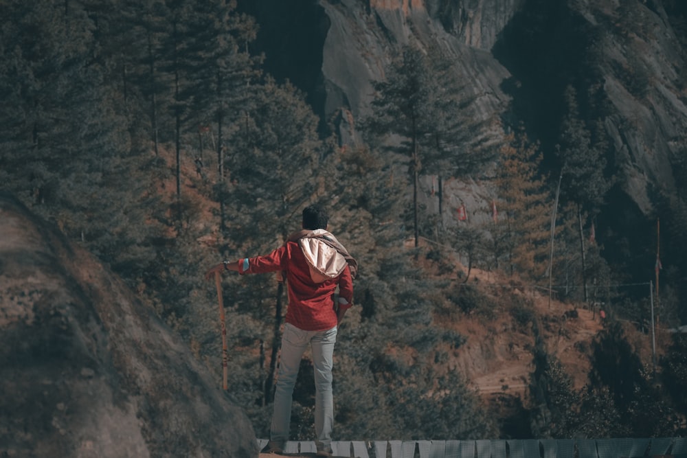 man standing on top of rock