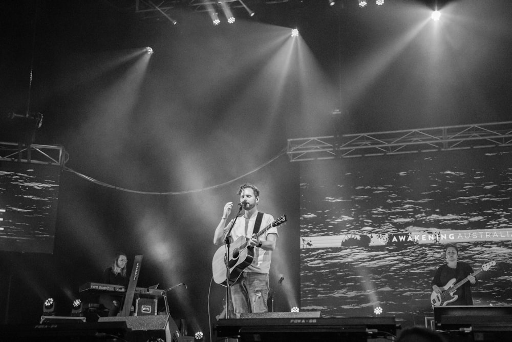 man playing on guitar on stage