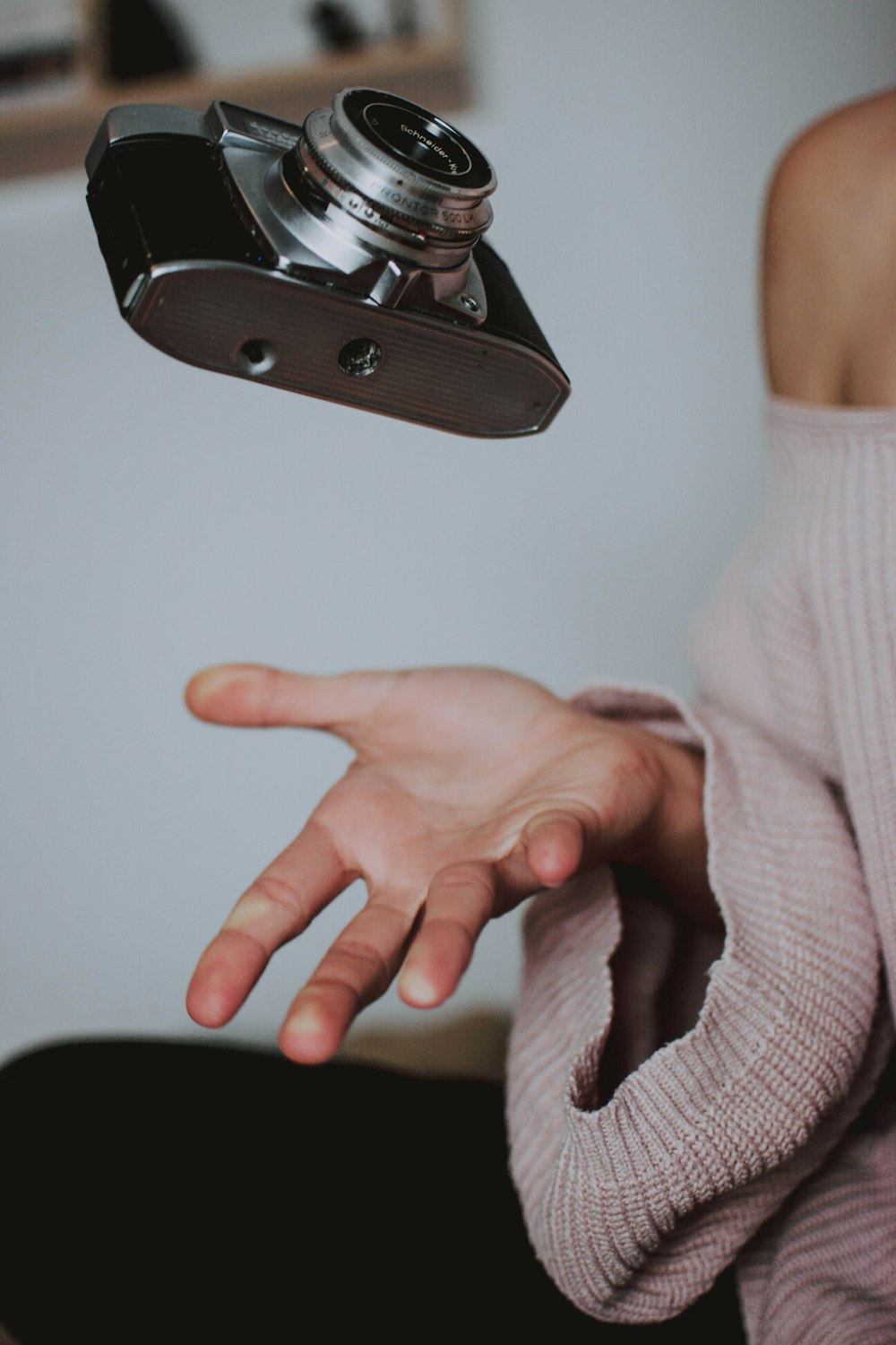 woman holding gray DSLR camera