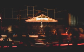 A roulette wheel spinning with blurred motion in a dimly lit casino environment.