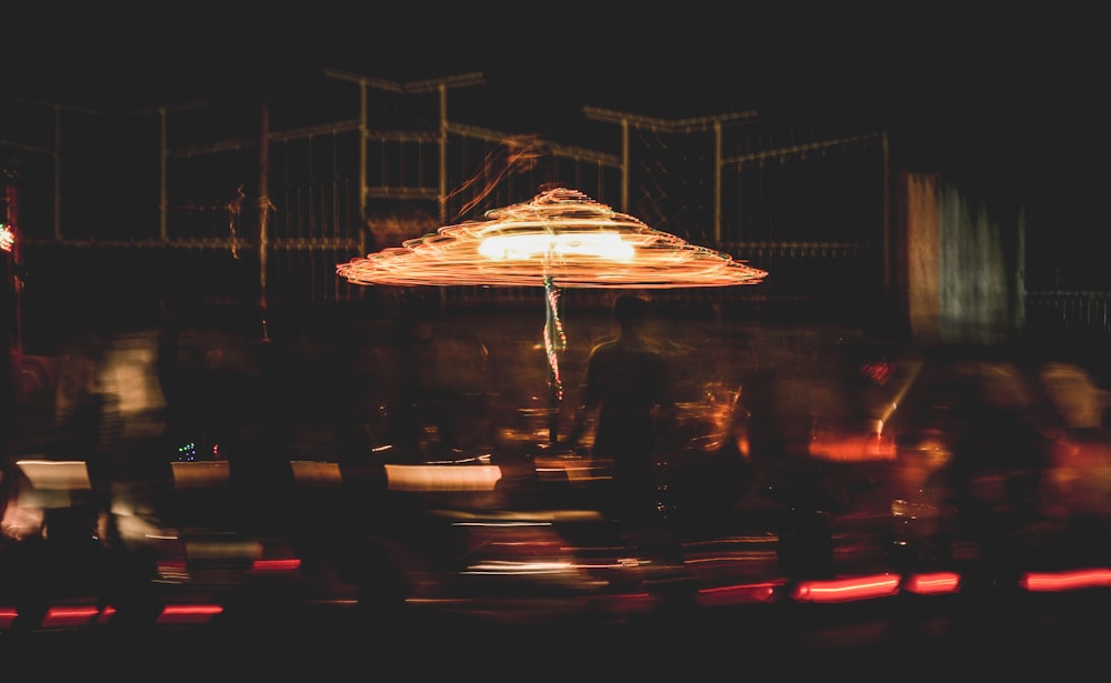 silhouette of person under of patio umbrella