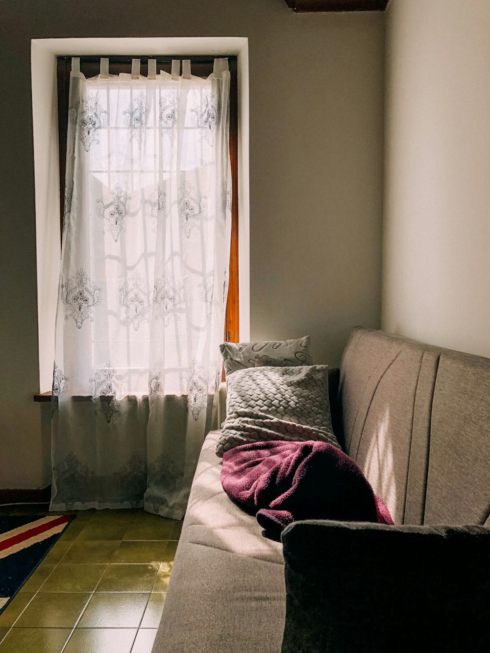 white window curtain near sofa