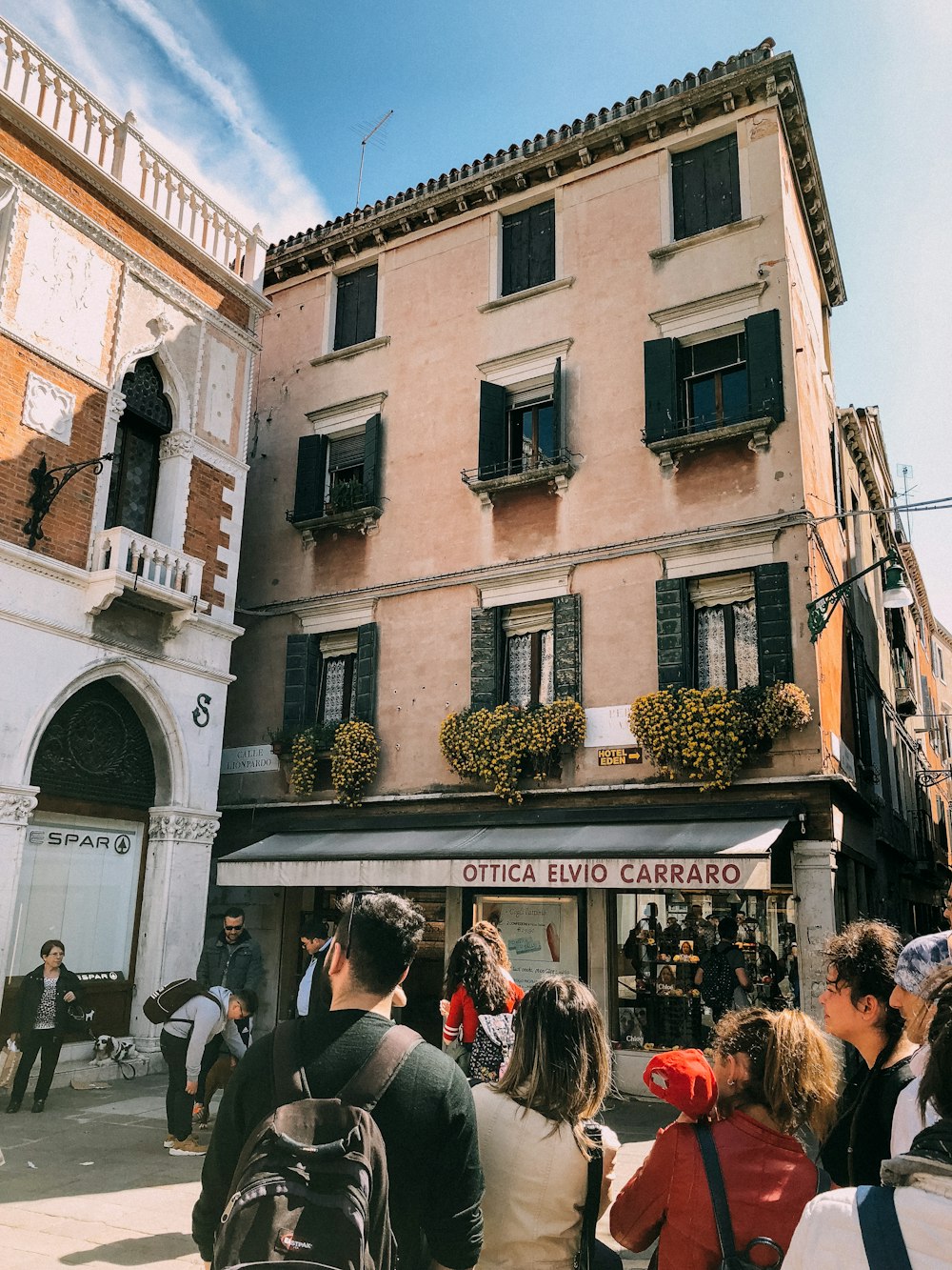 people near building under blue sky during daytime