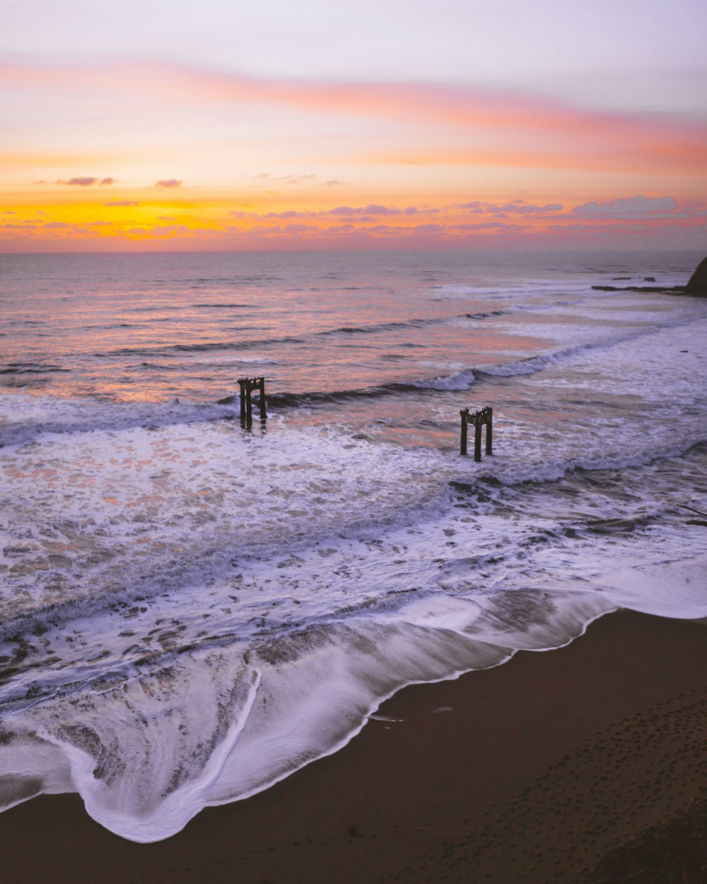 photo of seashore during sunset
