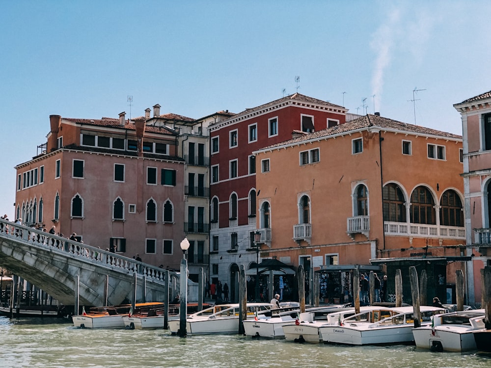 brown and red concrete buildings near body of water