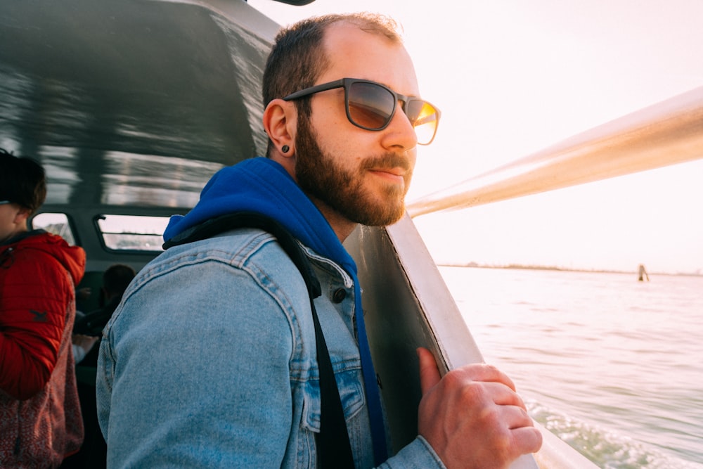 man wearing sunglasses watching sea