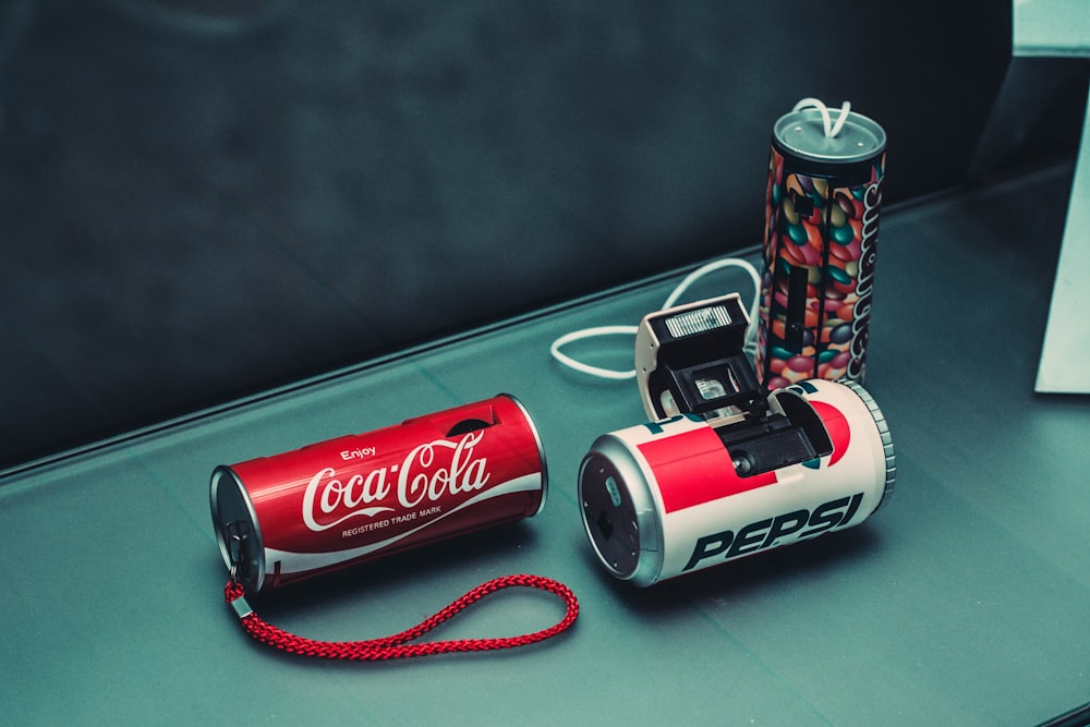 three assorted-color beverage can cameras