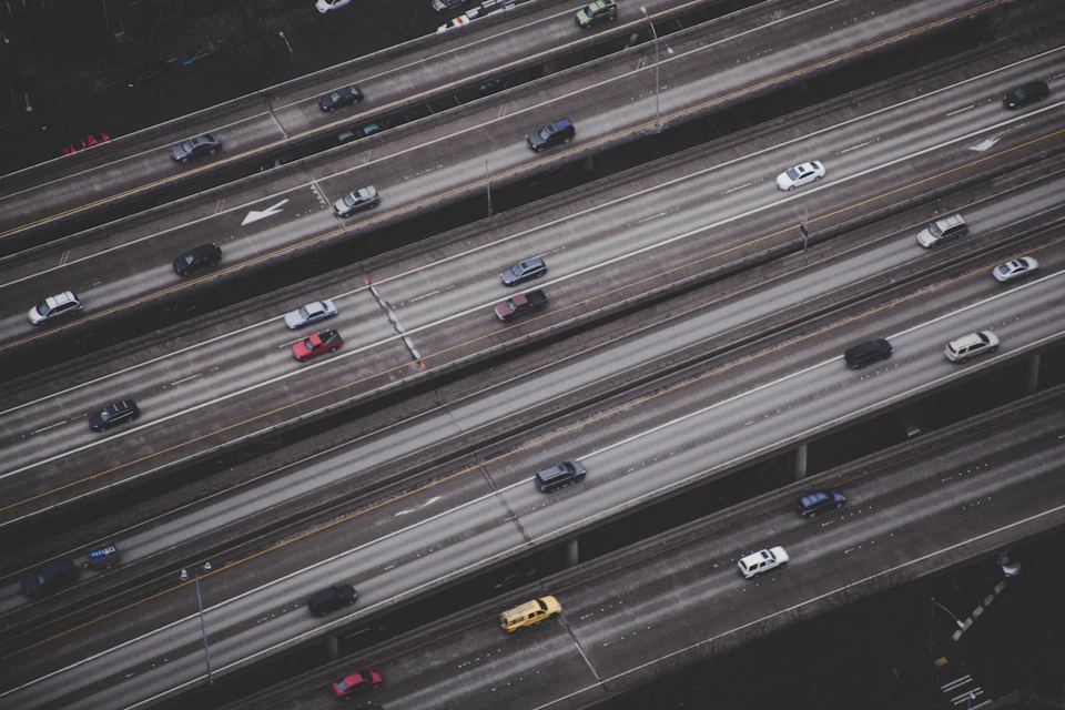 Busy highway with multiple lanes filled with cars moving in both directions