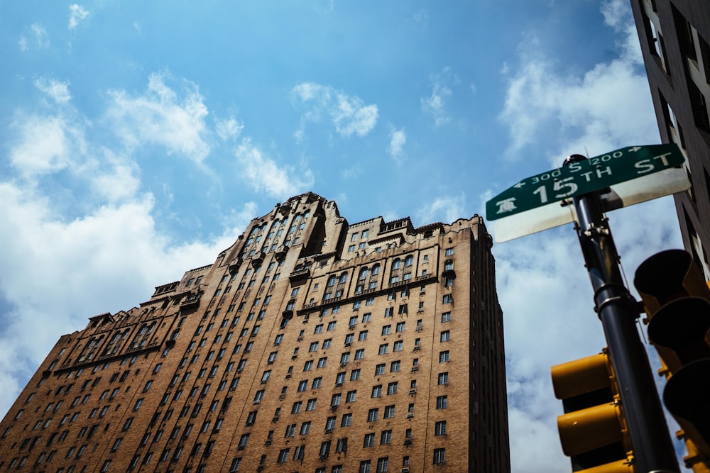 brown high-rise building under white and blue sky