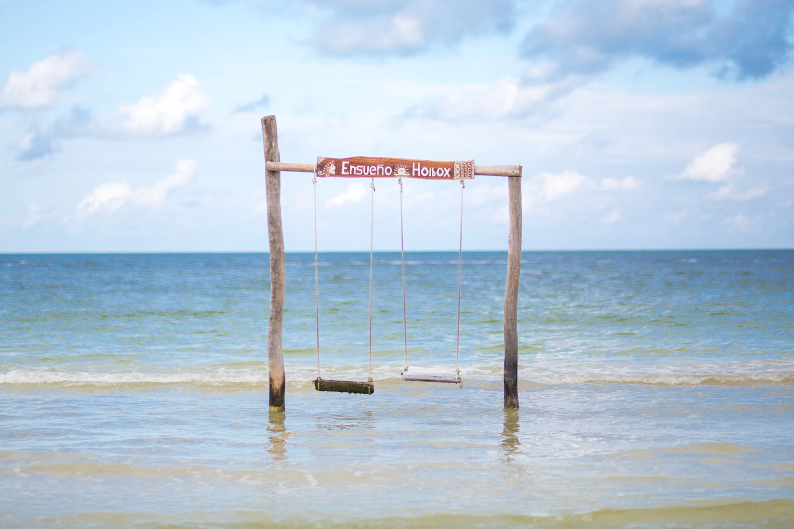 A swing over the shallow turquoise water on Isla Holbox