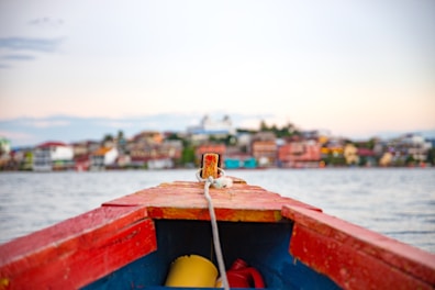 red and blue wooden canoe boat