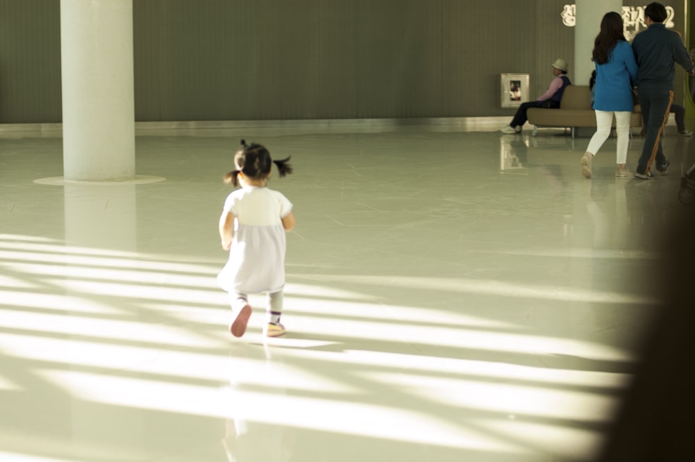 girl walking towards wall inside room