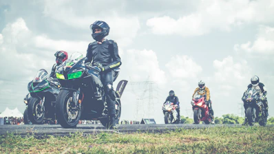 Group of motorcyclists lined up at the start of a private track day.