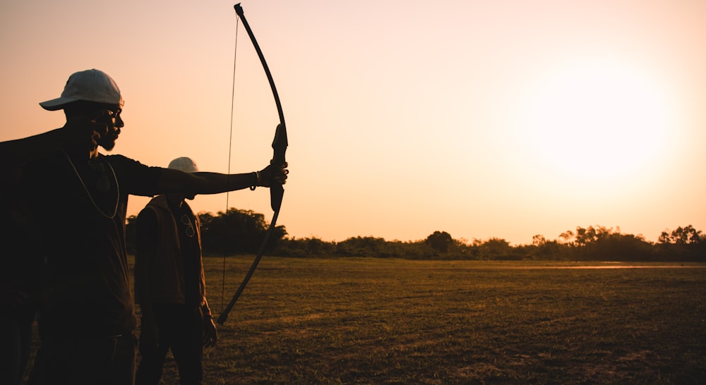 man holding bow during daytime