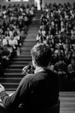 man speaking in front of crowd