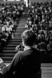 man speaking in front of crowd