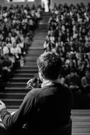 man speaking in front of crowd