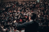 man speaking in front of crowd