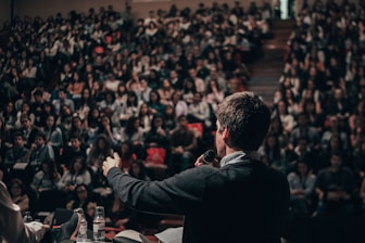 man speaking in front of crowd