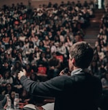 man speaking in front of crowd