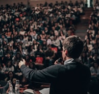 man speaking in front of crowd