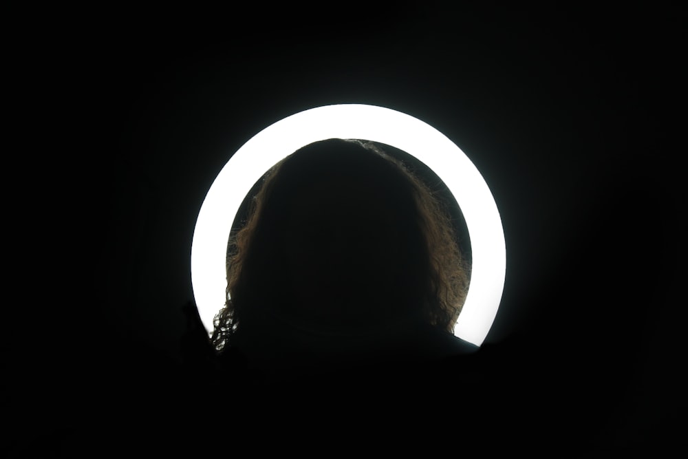 silhouette of person on against white light