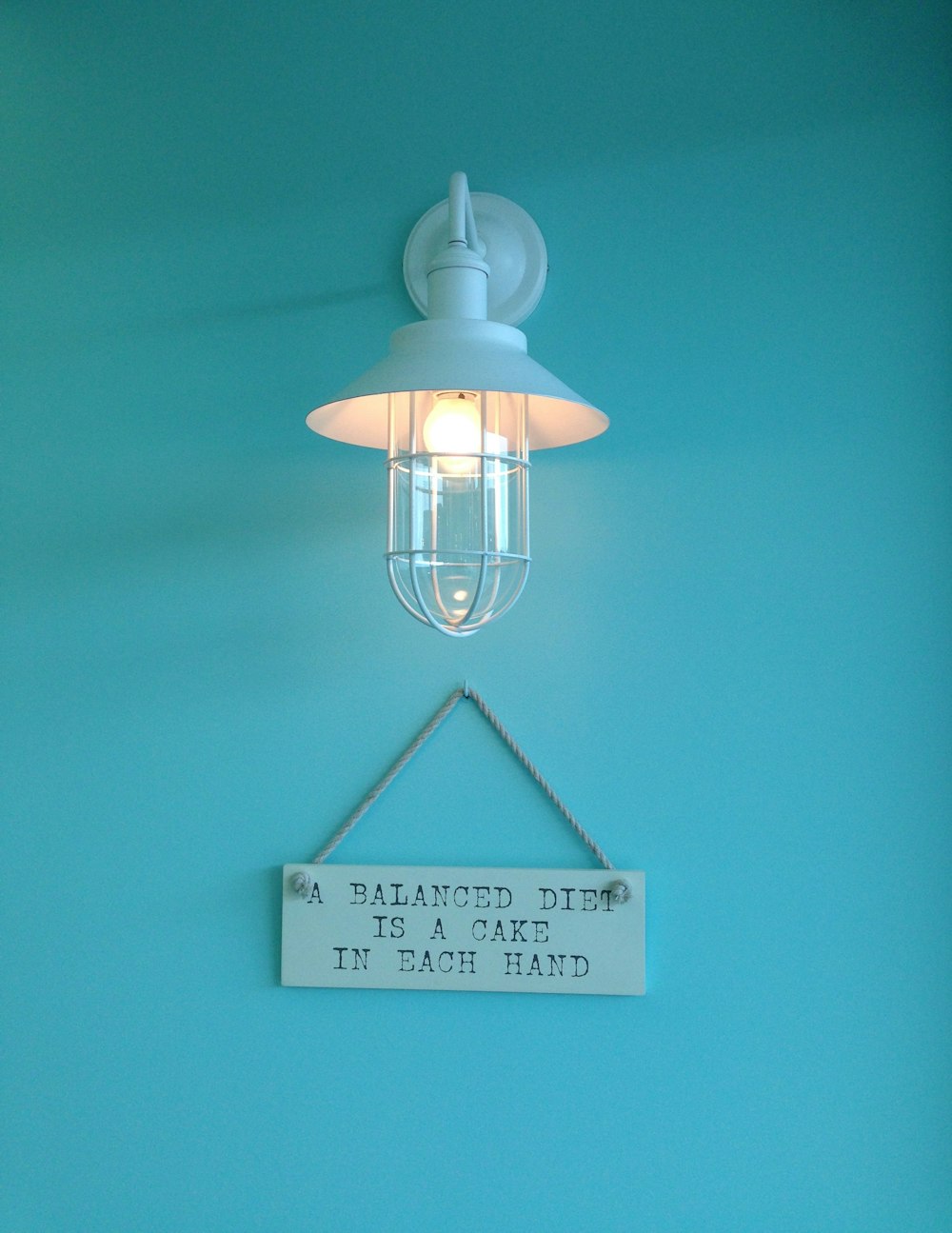 turned-on white wall lamp