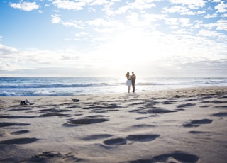 man and woman standing on shore