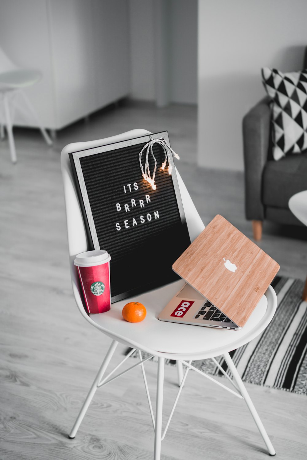 silver MacBook on white chair