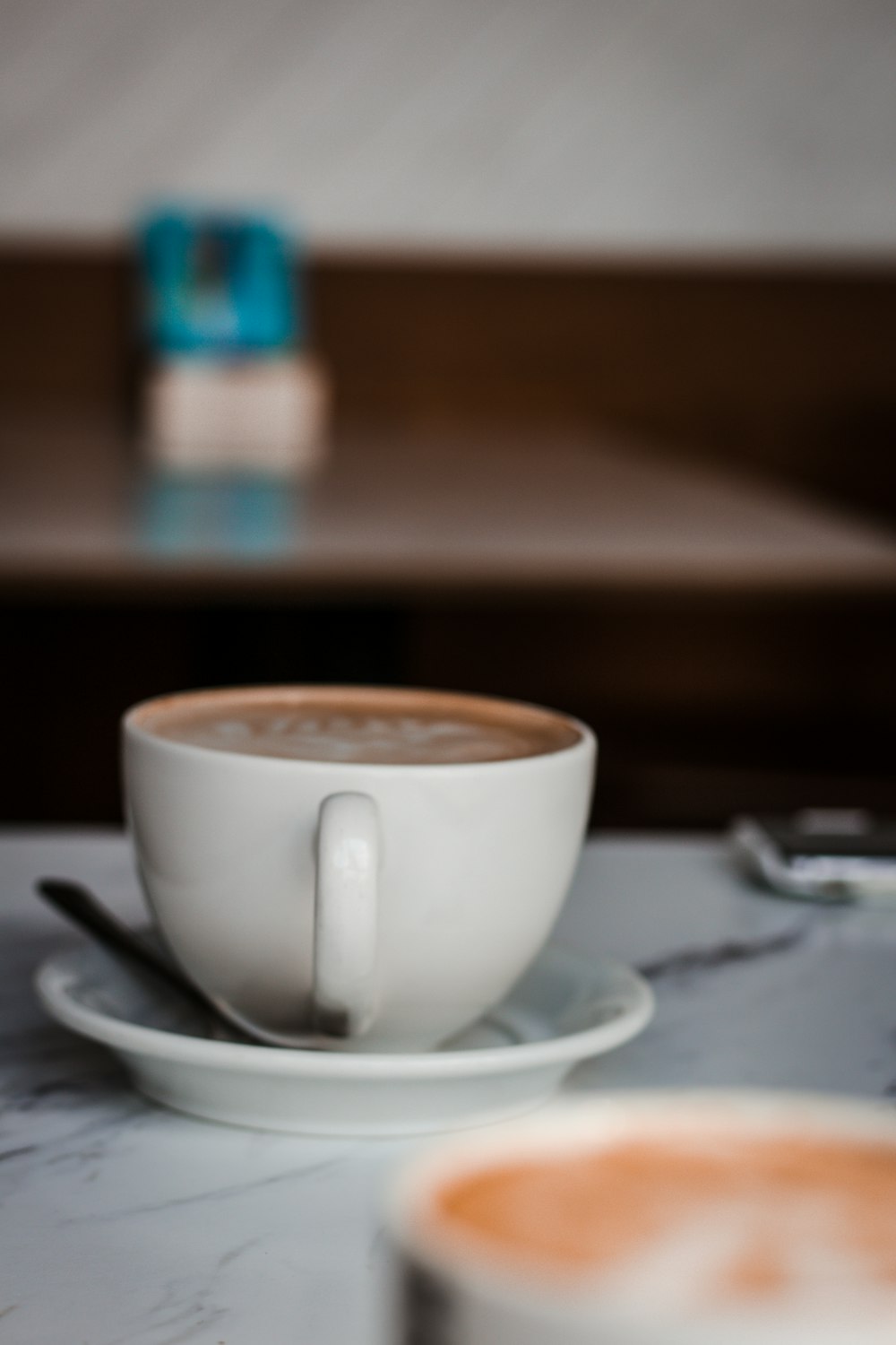 white ceramic teacup on saucer