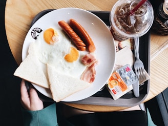 two sunny side up eggs on white plate